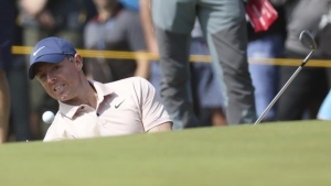 Bunker save on last hole helps McIlroy stay in contention